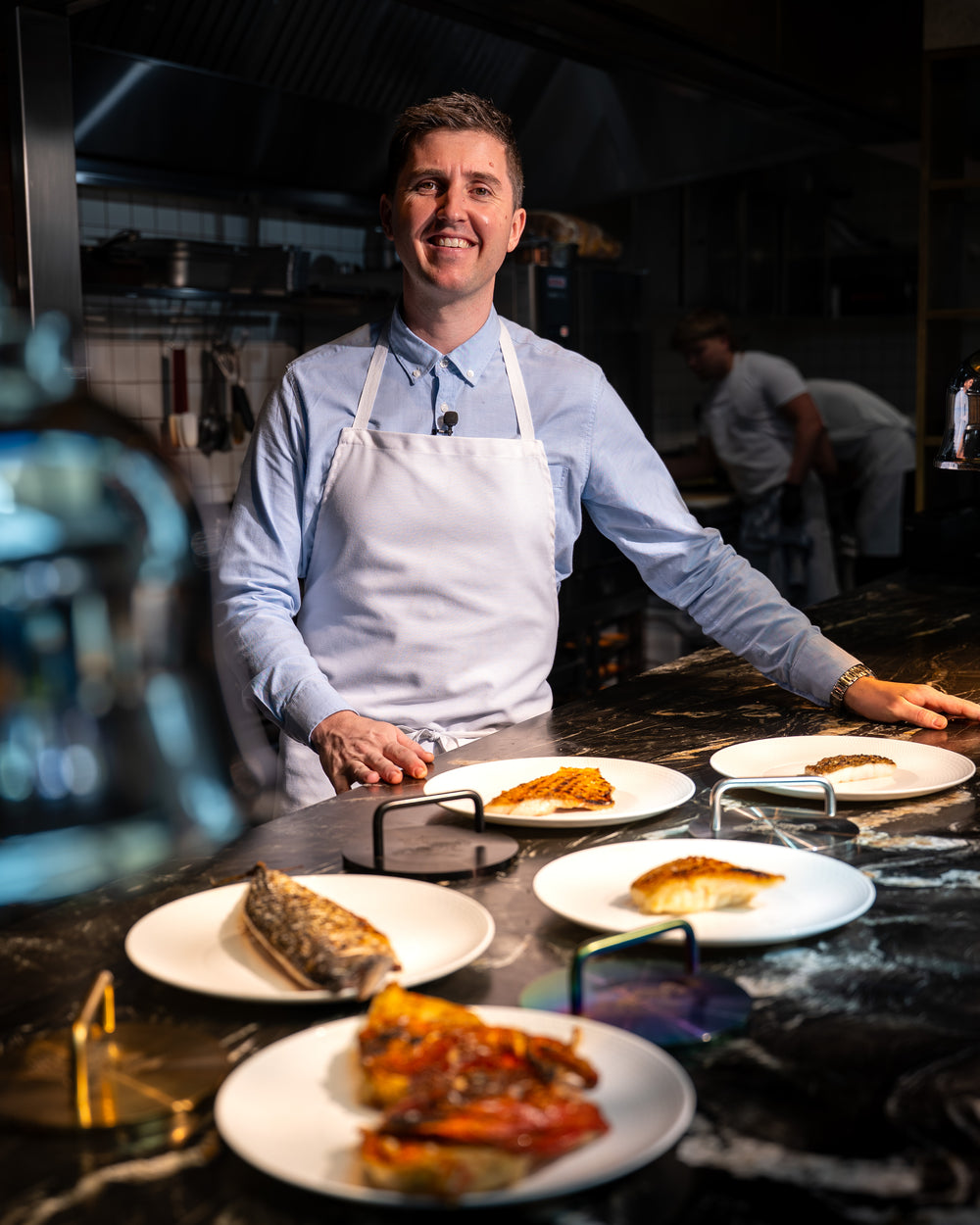 Josh Niland at the pass at Saint Peter with crisp skin fish and Fish Weights